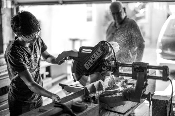 A volunteer building a project in a workshop